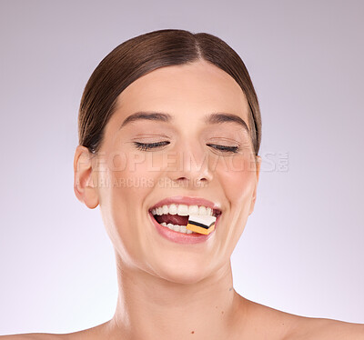 Buy stock photo Licorice, happy woman eating and mouth with makeup and cosmetics in an isolated studio. White background, sweet food and candy snack product with hungry female model face with sugar for dessert