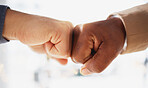 Business people, hands and fist bump in partnership, unity or trust for deal or agreement against blurred background. Hand of team bumping fists in collaboration, teamwork or goals in support for win