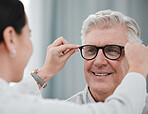 Optometry, ophthalmology and optometrist fitting glasses on senior man patient or happy client during appointment. Doctor, consultation and eyewear or spectacles for an elderly male for vision