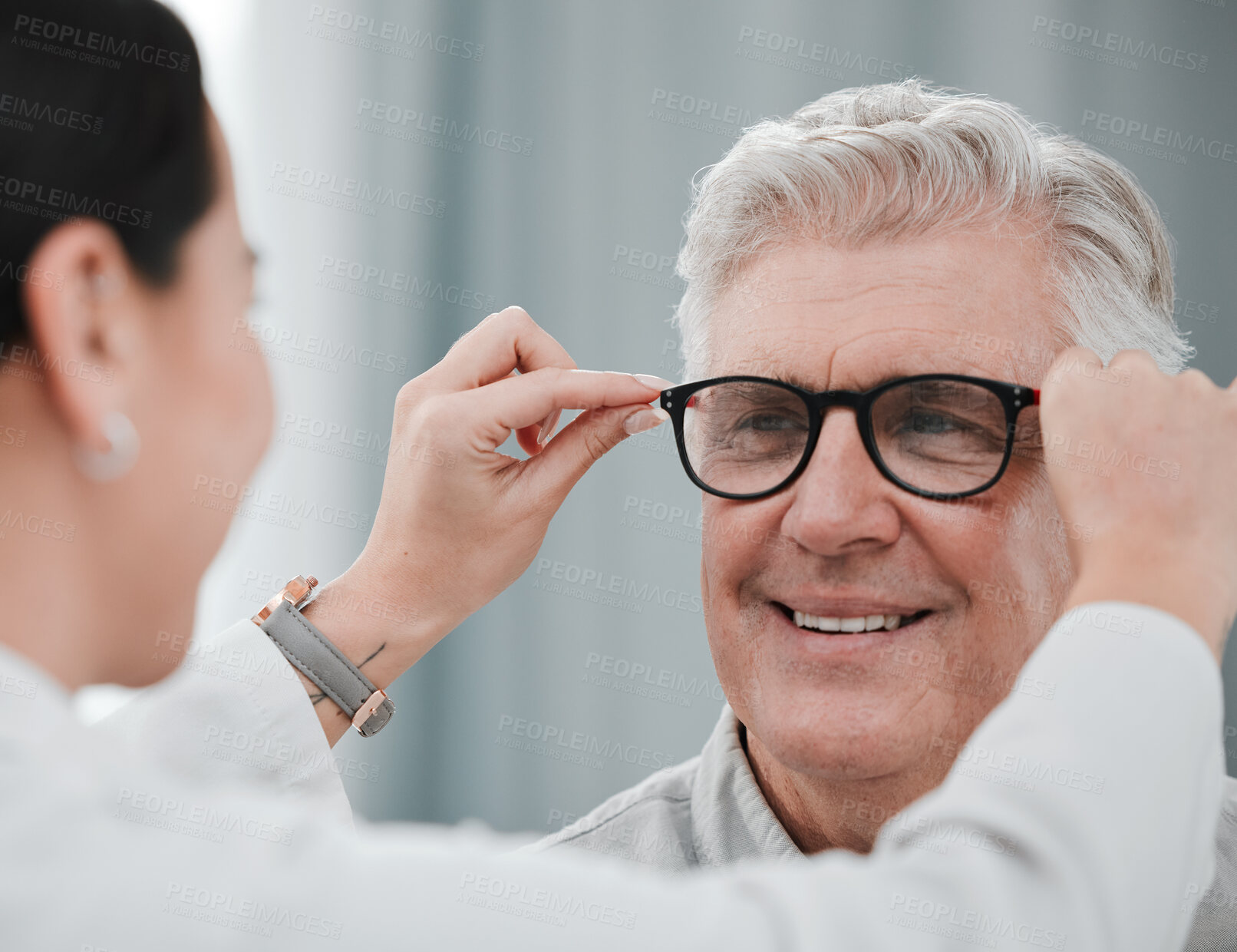 Buy stock photo Optometry, ophthalmology and optometrist fitting glasses on senior man patient or happy client during appointment. Doctor, consultation and eyewear or spectacles for an elderly male for vision