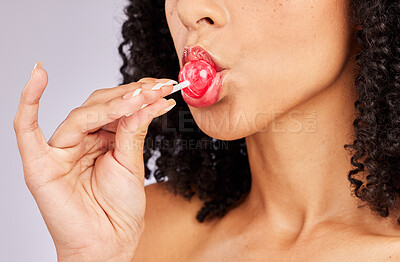 Buy stock photo Black woman, lollipop and lipstick with face and beauty, hand with makeup and lip gloss on studio background. Lips, cosmetic product and candy in mouth, cosmetics advertising and cosmetology