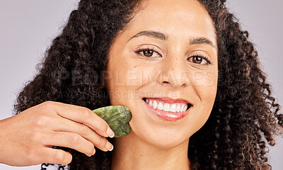 Buy stock photo Skincare, face portrait and black woman with gua sha in studio isolated on a gray background. Dermatology, cosmetics and happy female model with tool, stone or crystal for healthy skin and wellness.