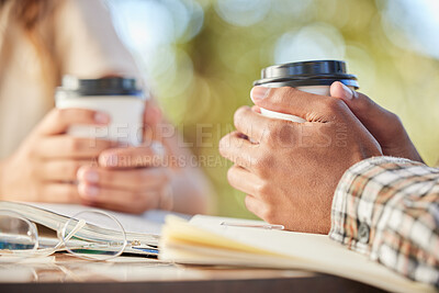 Buy stock photo Couple, coffee and hands outdoor on a date while studying, together and bonding at table. Hand of man and woman students with a drink or tea in disposable cup to relax with love and care at cafe