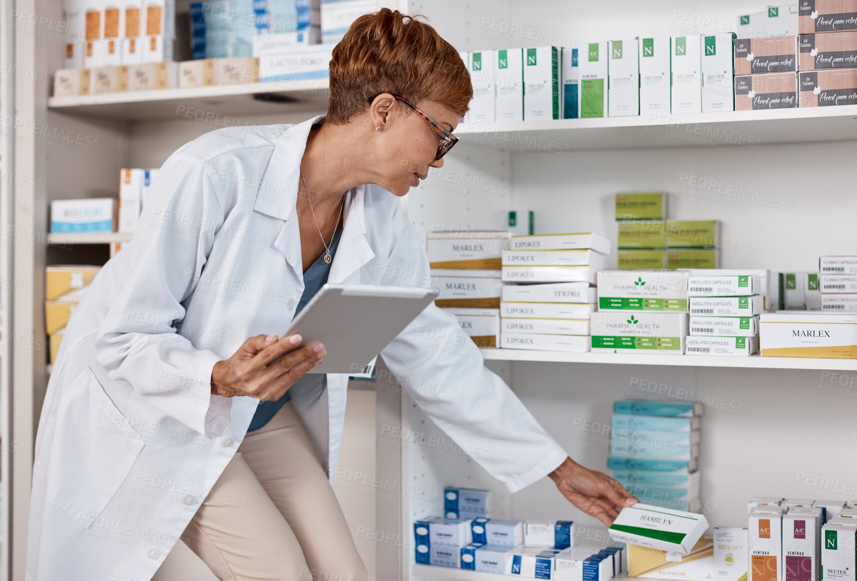 Buy stock photo Pharmacist woman, tablet and medicine shelf to check inventory and product information search. Person with pharmacy app in clinic or shop for pharmaceutical, medical and health care consultation