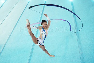 Buy stock photo Gymnast, woman with ribbon for dance and performance, flexibility with professional athlete in gym and top view. Rhythmic gymnastics, leg in air with fitness, grace and action, dancing and stretching