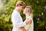 Park, love and couple hug for happy, quality time and bonding for engagement, vacation and holiday together. Dating, relationship and young man and woman hugging, relax and romantic embrace in nature