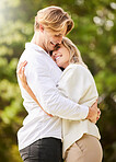 Park, dating and couple hug for happy, quality time and bonding for engagement, vacation and holiday together. Dating, love and young man and woman hugging, relax and romantic embrace in nature