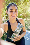 Portrait, selfie and woman with water smile after yoga, workout or cardio training in nature, happy and excited. Face, social media and girl health influencer pose for photo, profile picture or blog 