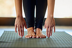 Hands, feet and woman stretching on yoga mat for exercise, cardio and flexibility warm up in her home. Barefoot, hand and girl stretch for meditation, training for pilates workout in a living room