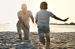 Fun, playful and father with a child at the beach for bonding, quality time and playing in Spain. Freedom, happy and smiling father catching a running boy at the ocean for love, care and enjoyment