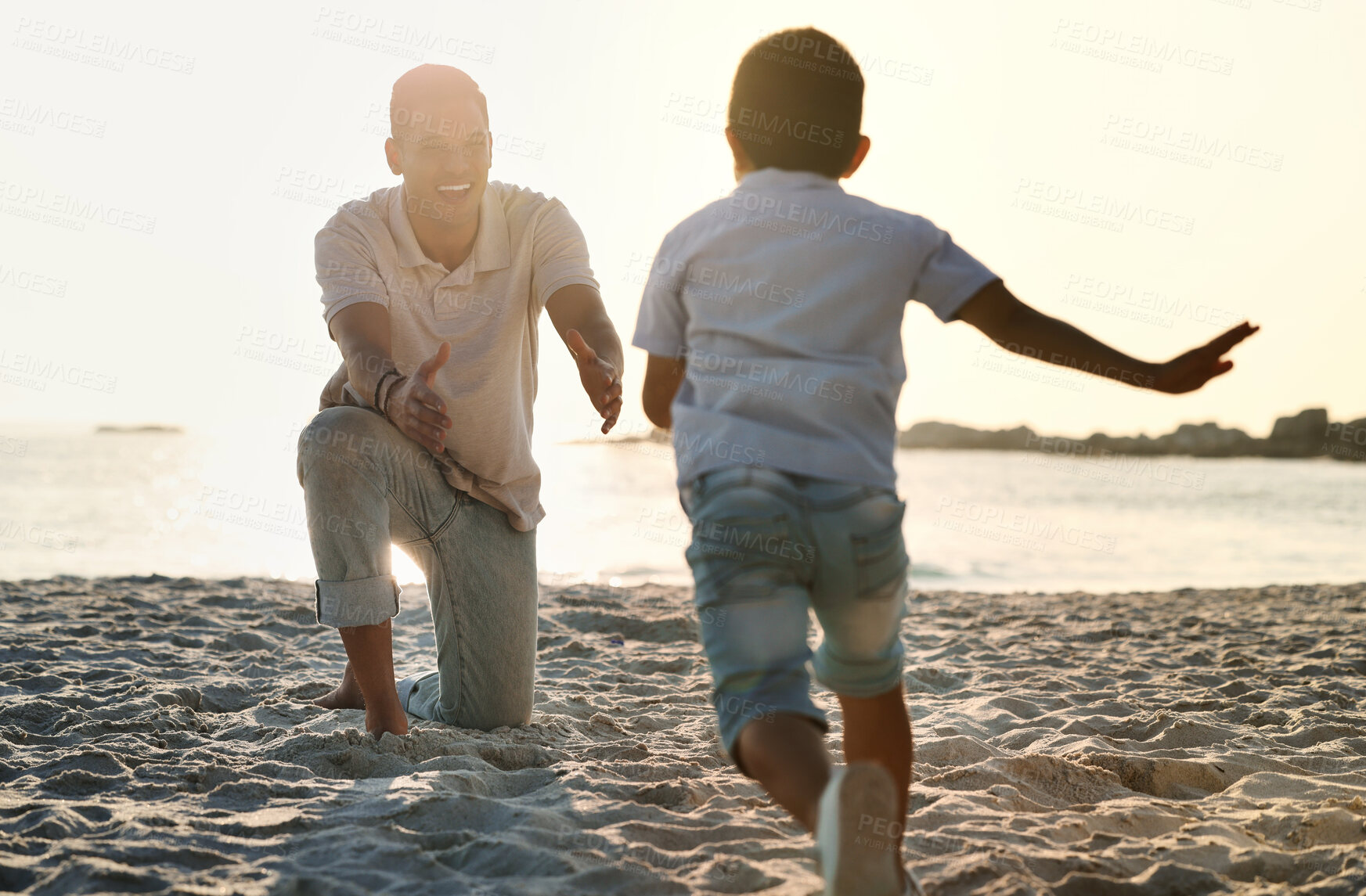 Buy stock photo Fun, playful and father with a child at the beach for bonding, quality time and playing in Spain. Freedom, happy and smiling father catching a running boy at the ocean for love, care and enjoyment