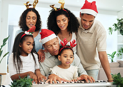 Buy stock photo Black family, christmas singing and together at piano for learning, festive celebration or bonding. Father, teaching and girl at keyboard for development, education or holiday for music, mom and kids