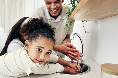 Buy stock photo Portrait of a girl washing her hands with her family in the kitchen of their modern home. Happy, smile and child cleaning her hand with her father to get rid of bacteria, germs and dirt in a house.