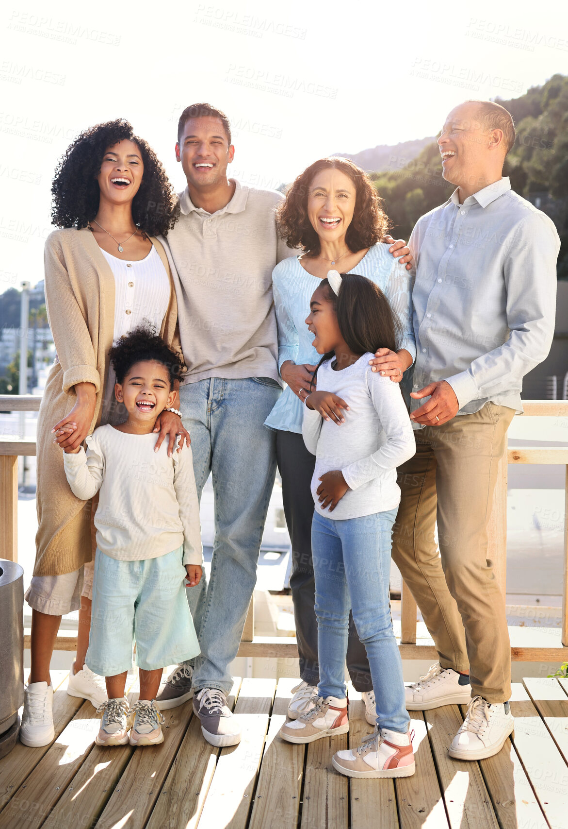 Buy stock photo Love, happy and portrait of a big family outdoor on the balcony of their modern house. Happiness, smile and girl children siblings standing with their parents and grandparents outside of the home.