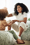 Happy, hairstyle and mother with daughter in living room for care, bonding or affectionate. Grooming, cosmetics and help with black woman and child in family home for touch, beauty or morning routine