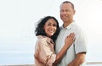 Buy stock photo Portrait, smile and senior couple by beach, hug and enjoying quality time on holiday or vacation. Love, care and retired happy man and woman hugging, embrace or cuddle while having fun by ocean.