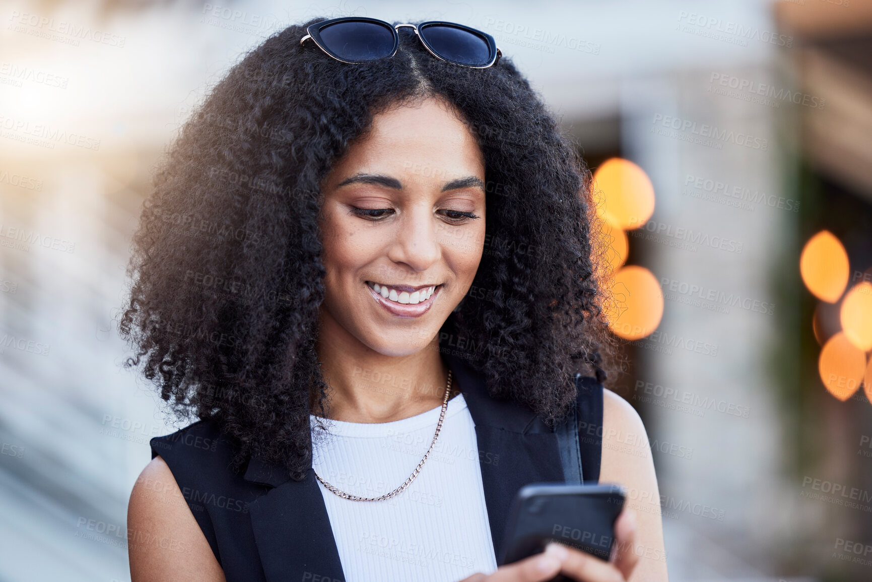 Buy stock photo Young black woman, phone and texting in city with smile, online date and social media app for contact. Happy gen z girl, smartphone and internet communication with digital ux, chat and walk in street