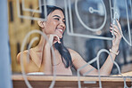 Coffee shop, selfie and window with a woman customer sitting at a table in a restaurant on the weekend. Social media, mobile and relax with an attractive young female taking a photograph in a cafe