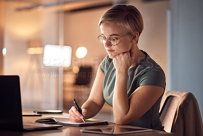 Buy stock photo Business woman, book or writing in night office for company planning, schedule or ideas management. Serious, corporate or worker with notebook pen, laptop technology or project agenda of evening task