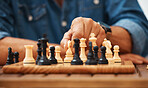 Chess, play and hands with a knight on a board game with a strategy in home competition. Checkmate, chessboard and smart man or male playing in a sports contest or problem solving challenge for mind.