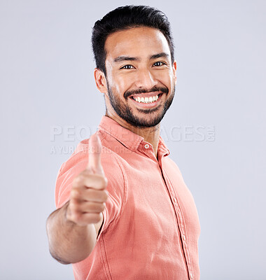 Buy stock photo Thumbs up, yes and like with portrait of man for vote, well done and promotion for good news. Happy, smile and emoji with guy and positive hand gesture for thank you, agreement and approval in studio