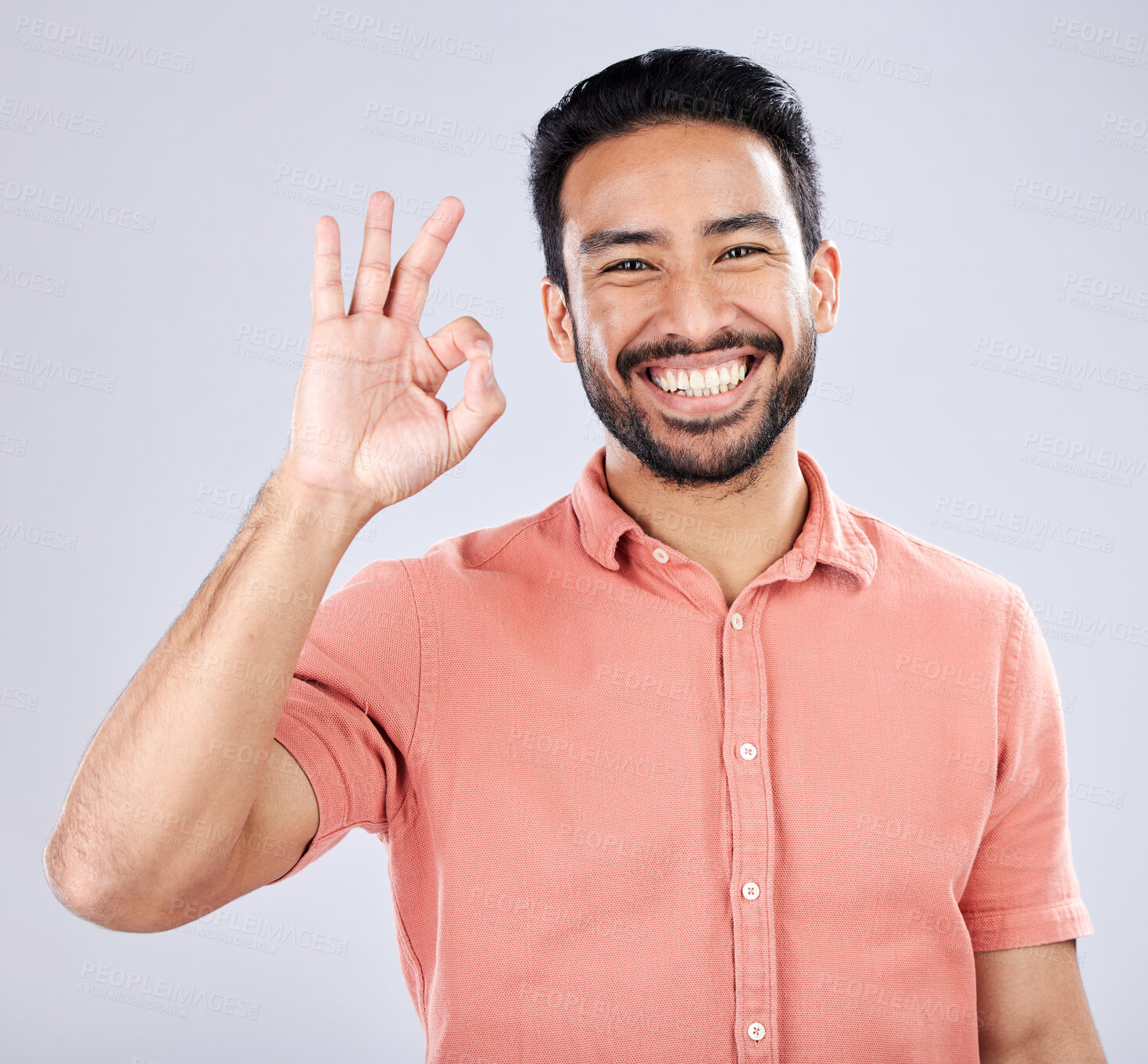 Buy stock photo Portrait, hand sign and perfect with a man in studio on a gray background to gesture okay. Emoji, success and good news with a handsome young man indoor to display his approval or agreement