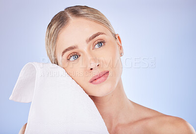 Buy stock photo Face, beauty and woman with towel to wipe in studio isolated on a purple background. Thinking, makeup cosmetics and skincare of female model with fabric or cloth for facial wiping for healthy skin.