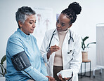 Black woman, doctor and senior patient with blood pressure reading for wellness, advice and conversation. Medic, elderly client and medical tools for health, cardiology and results in hospital office