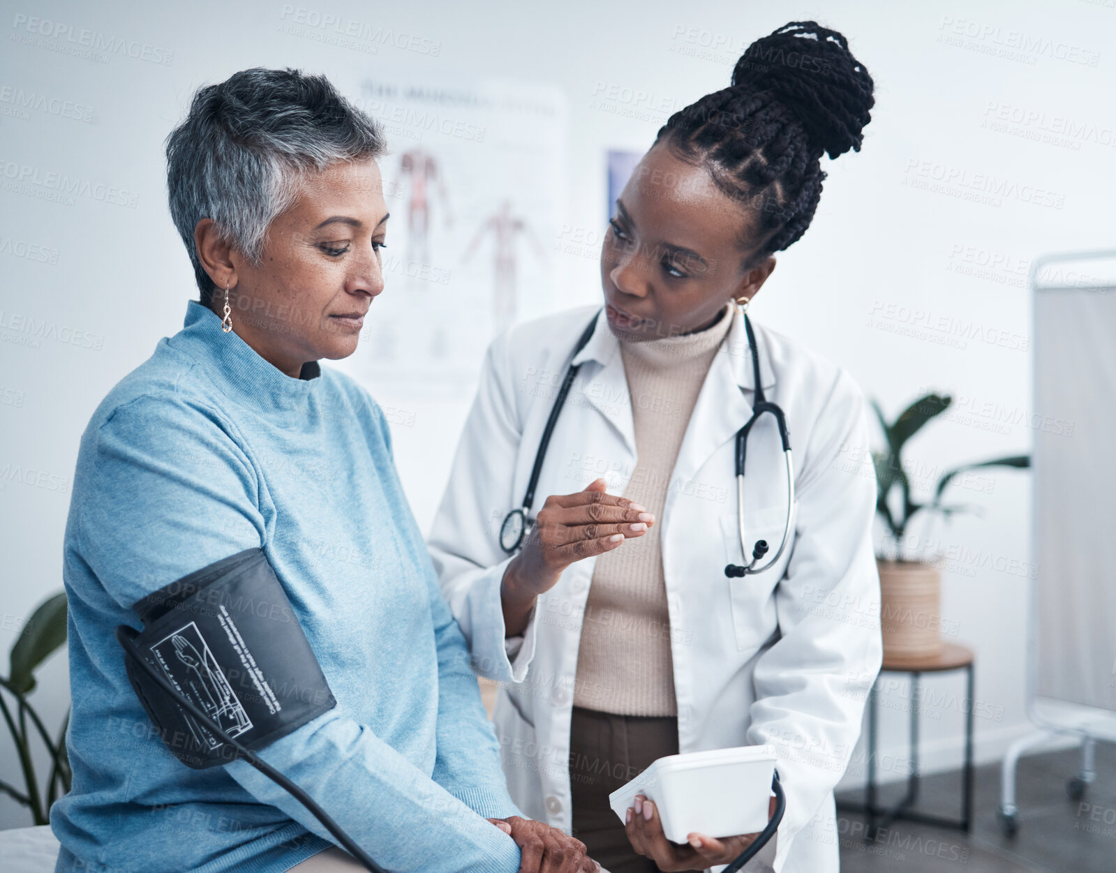 Buy stock photo Black woman, doctor and senior patient with blood pressure reading for wellness, advice and conversation. Medic, elderly client and medical tools for health, cardiology and results in hospital office