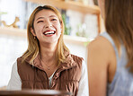 Smile, friendship and women laughing together in cafe, happy talking and gossip or joke on weekend. Happy, laugh and smiling friends in restaurant for brunch date with asian woman and friend at table