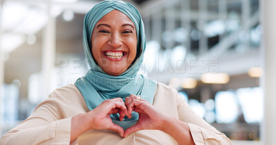 Face, hands and heart with a muslim businesswoman walking in her office while happy at work. Portrait, laughing or smile with an islamic and carefree woman employee taking a walk while working