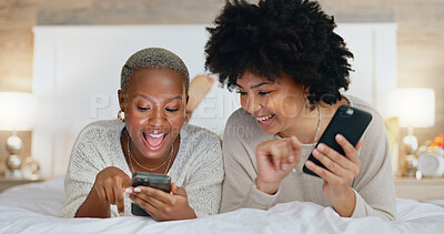 Friends, phone and girls night in bedroom on social media. Happy, smile and black woman on bed with friend watching funny video. Women at sleep over, reading and exited for online dating app message.