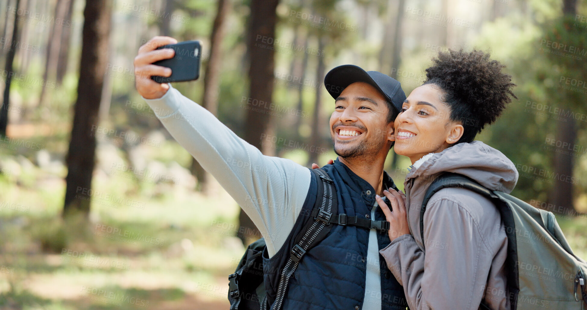 Buy stock photo Hiking selfie, forest and couple for travel, outdoor  journey or adventure on social media in nature, fitness gear and backpack. Trekking profile picture of young influencer or happy people in woods