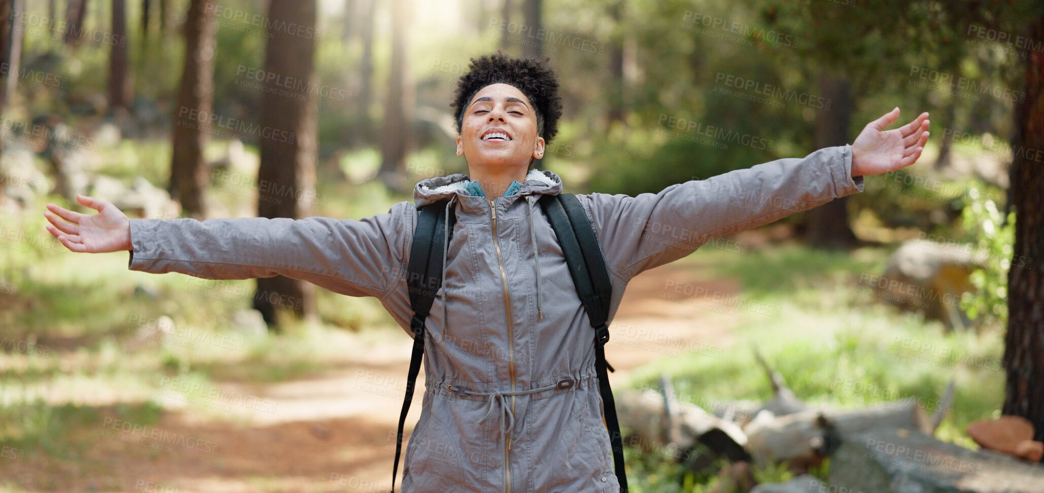 Buy stock photo Freedom, arms and a woman hiking in the forest for travel or adventure as a tourist to explore nature. Health, wellness and fresh air with a young person outdoor in the woods to relax on a hike