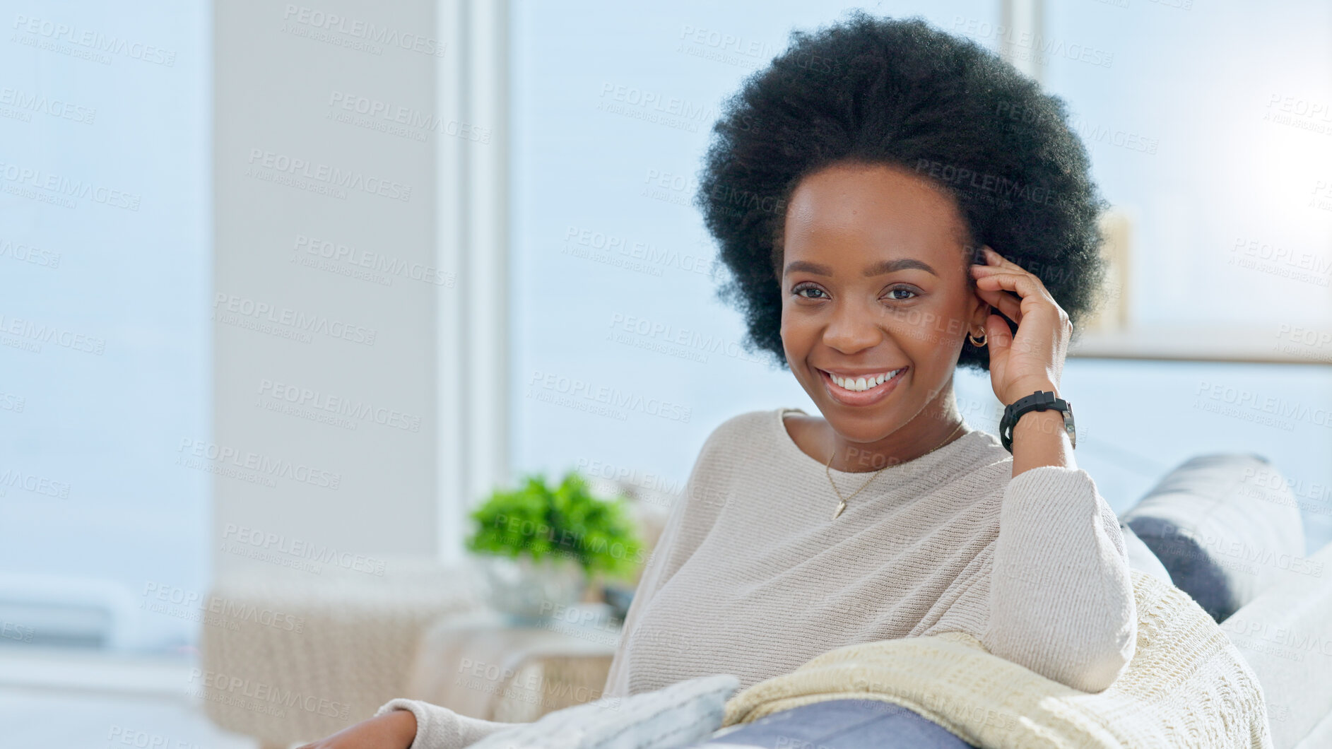 Buy stock photo Portrait, smile and relax with a black woman on a sofa in the living room of her home on the weekend. Face, happy and afro with a young person in her apartment for peace or quiet on a lazy sunday