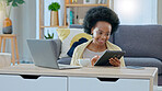 Women relaxed with coffee, sitting on the floor, back against the sofa reading email, checking social media or streaming movie at home. Weekend, woman on couch with computer and a coffee break in living room on internet.