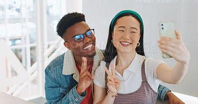 Buy stock photo Happy, selfie and couple with love, peace sign or symbol with profile picture, support or blog post. People, Asian woman or black man with love, smartphone or connection with kindness, home or memory