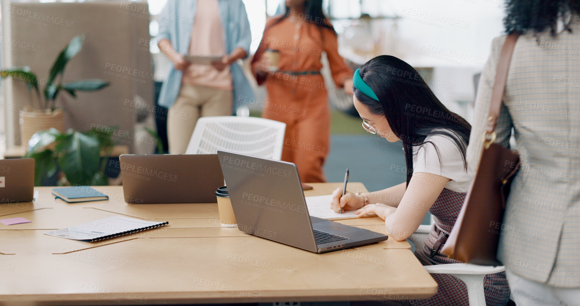 Buy stock photo Asian woman in office, writing notes and laptop for market research, email or online report at startup. Creative businesswoman in coworking space with computer, book and business ideas at tech agency