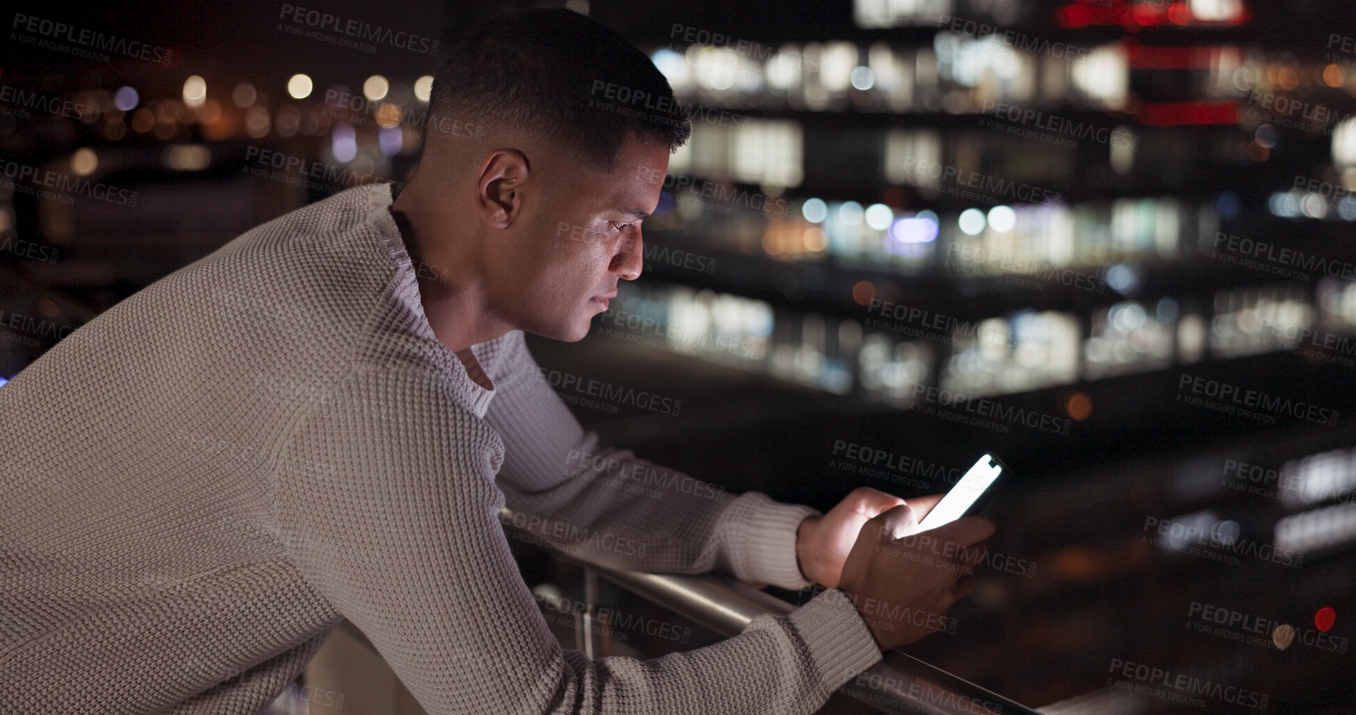 Buy stock photo Phone, night and business man on balcony in city, reading email or network on social media app. Smartphone, rooftop and serious professional outdoor on internet, creative and communication on bokeh