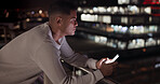 Business man, phone and night data while online on an urban building rooftop typing email, search or communication for networking on trading app. Entrepreneur on terrace in dark with 5g network