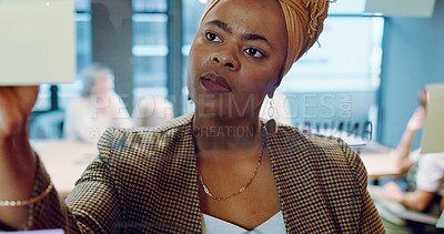 Black business woman, post it and writing planning notes on glass wall for business meeting, presentation training or leadership in modern office. African woman, leader thinking and SEO strategy idea