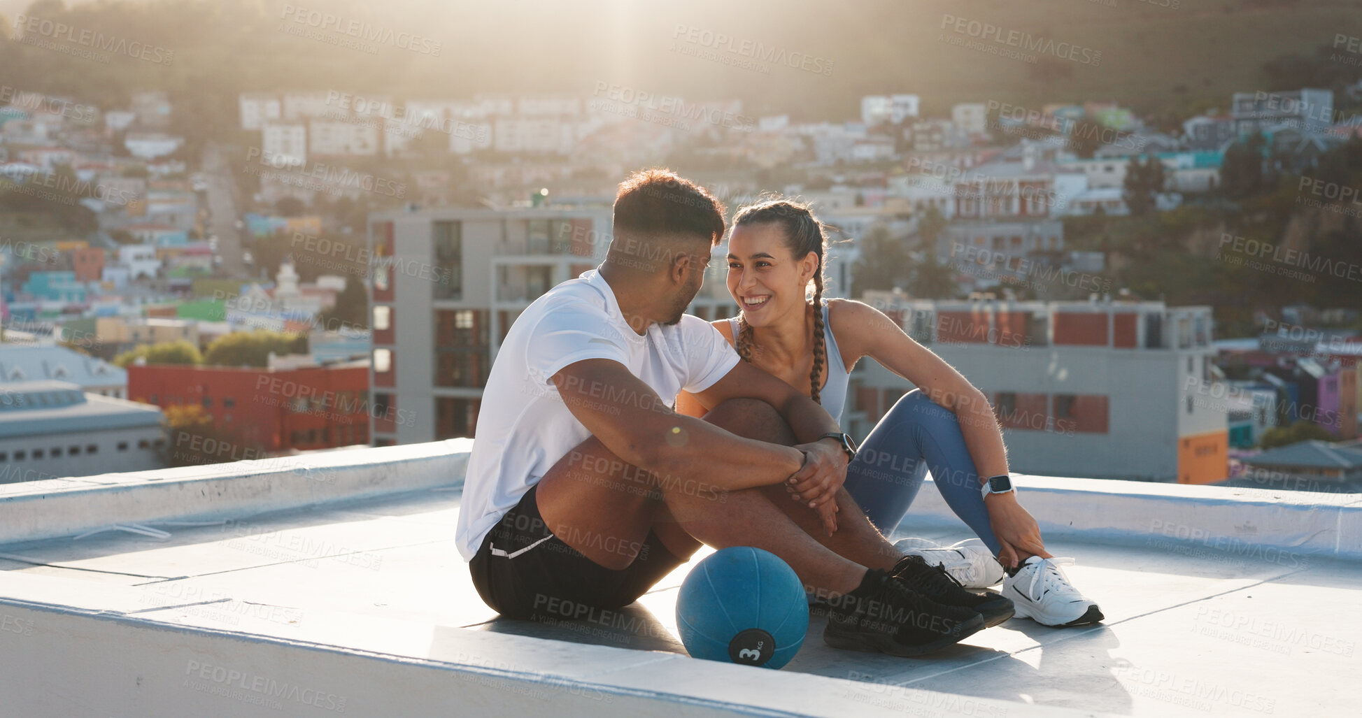 Buy stock photo Fitness, rest and happy couple outdoor for exercise, workout or training together on a city building rooftop. Man and woman on urban break with medicine ball, conversation or health and wellness