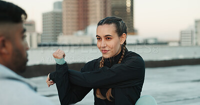 Buy stock photo Fitness, personal trainer and stretching on rooftop in city for exercise, sport or outdoor workout. Woman and man coaching in sports practice, body warmup or cardio together in an urban town