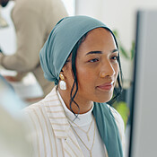 Woman, startup and desk with computer, reading and coding in modern ...