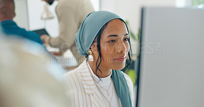 Woman, startup and desk with computer, reading and coding in modern office with islamic headscarf. Muslim programming expert, developer and web design worker with vision, tech solution and happiness