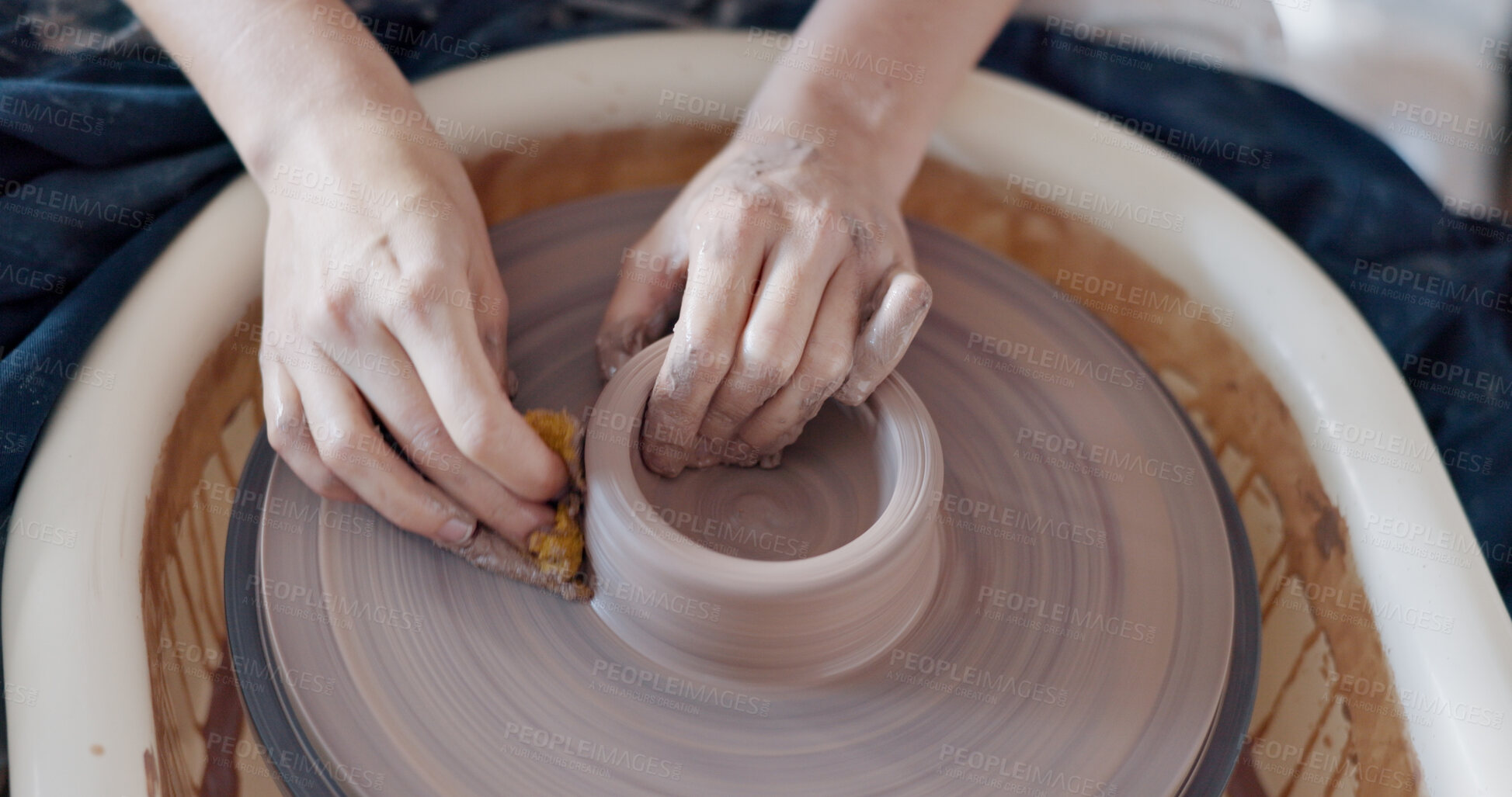 Buy stock photo Pottery, wheel and hands to mold clay container in studio, workshop or classroom. Artist, craft and hobby with creativity, unique mug, cup or handmade ceramic bowl with design and process from above