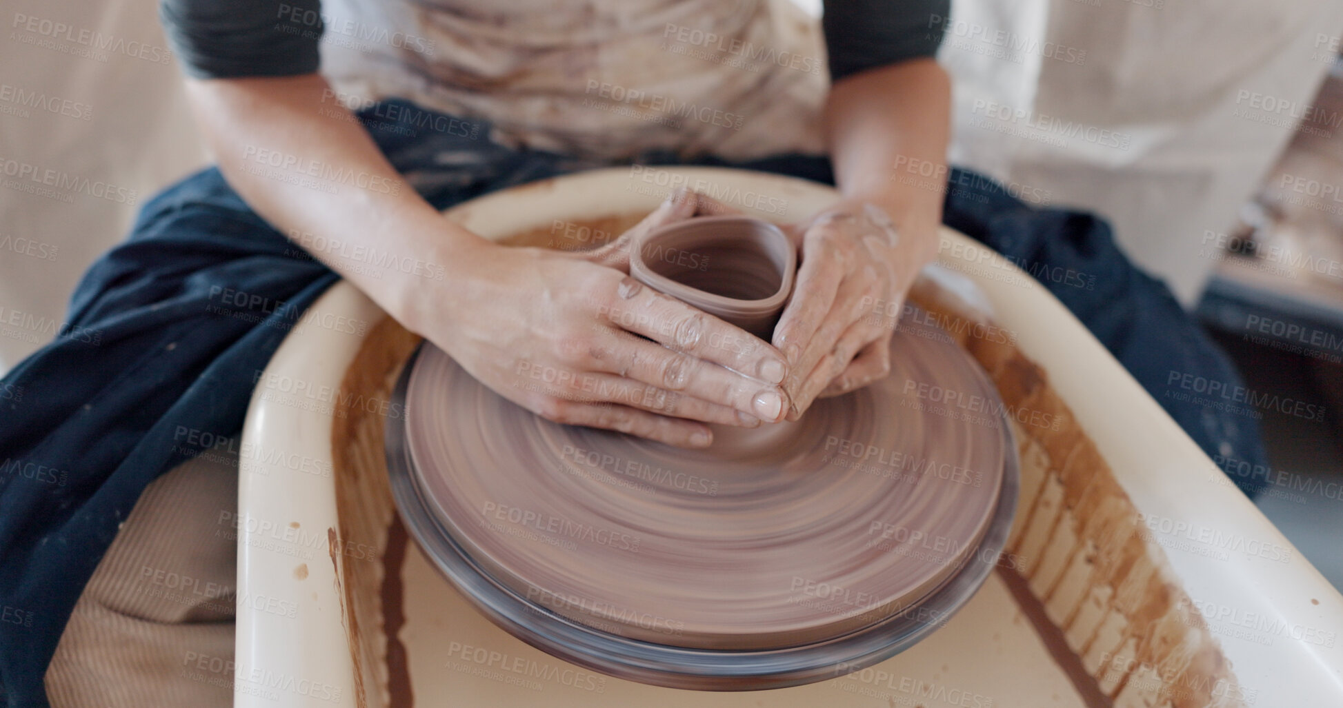 Buy stock photo Art, hands and clay on wheel to mold container or bowl in studio, workshop or class. Artist, person and student with creative, unique pottery or shape for ceramic product design process with care.