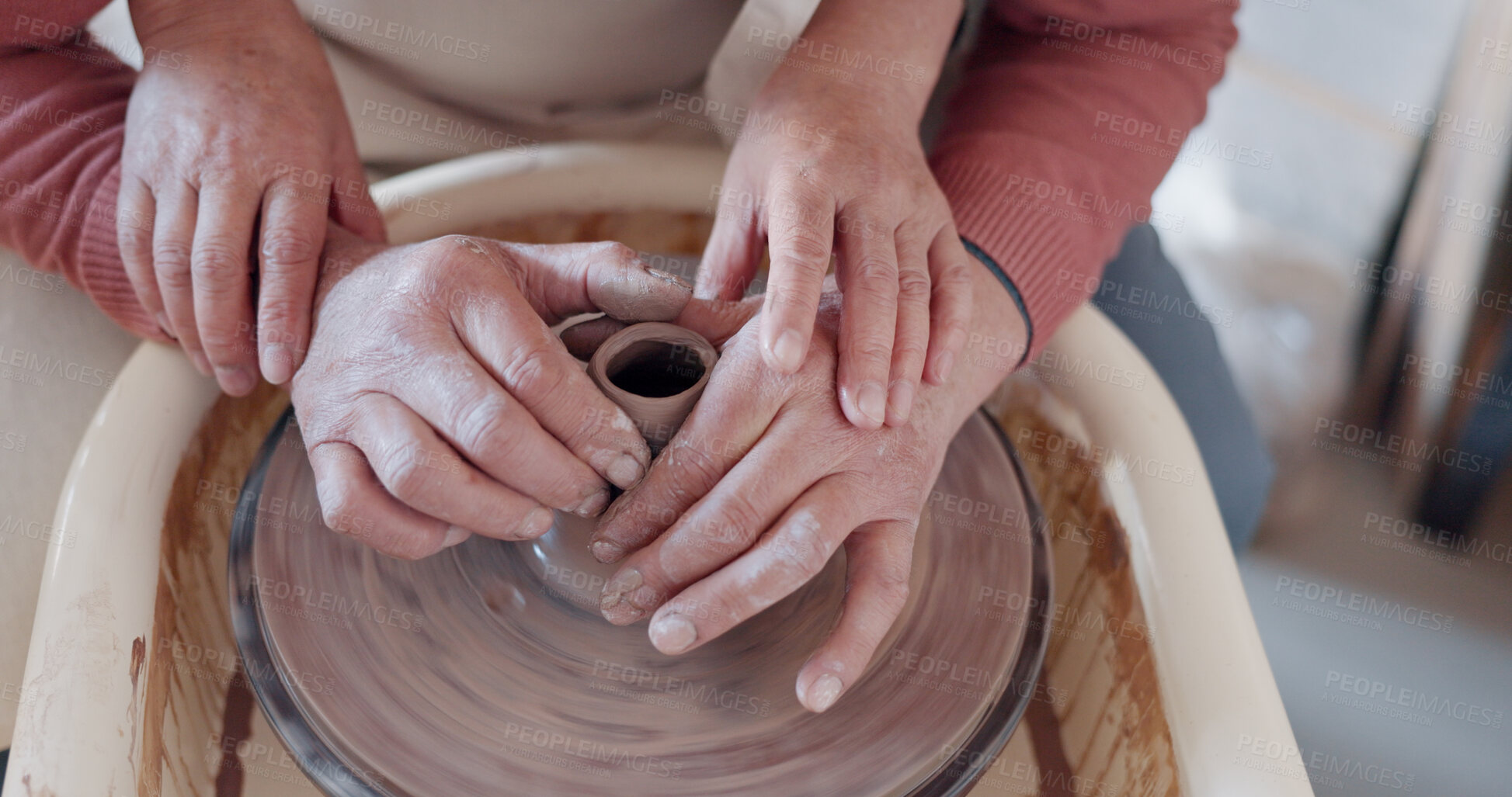 Buy stock photo Art, hands and clay on wheel together, help with container or bowl in studio, workshop or pottery class. Artist, teacher and student with creative, unique mold or shape for ceramic product design.