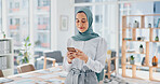 Phone, thinking and feedback with a business muslim woman typing a text message in her office at work. Contact, mobile and idea with an islamic female employee reading an email while working alone