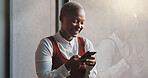 Happy, smile and face of a black woman on a phone while standing by the window in office. Technology, happiness and African female employee networking on social media or the internet on break at work